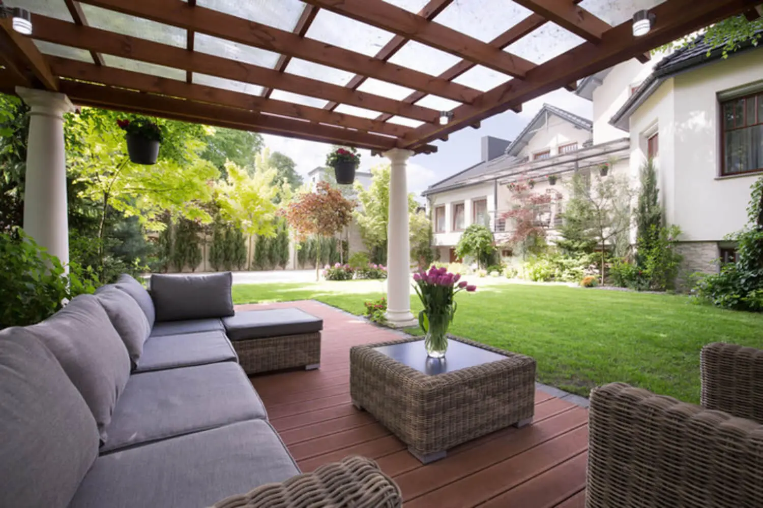 Custom wood pergola with lattice roof shading a luxury outdoor patio and seating area.