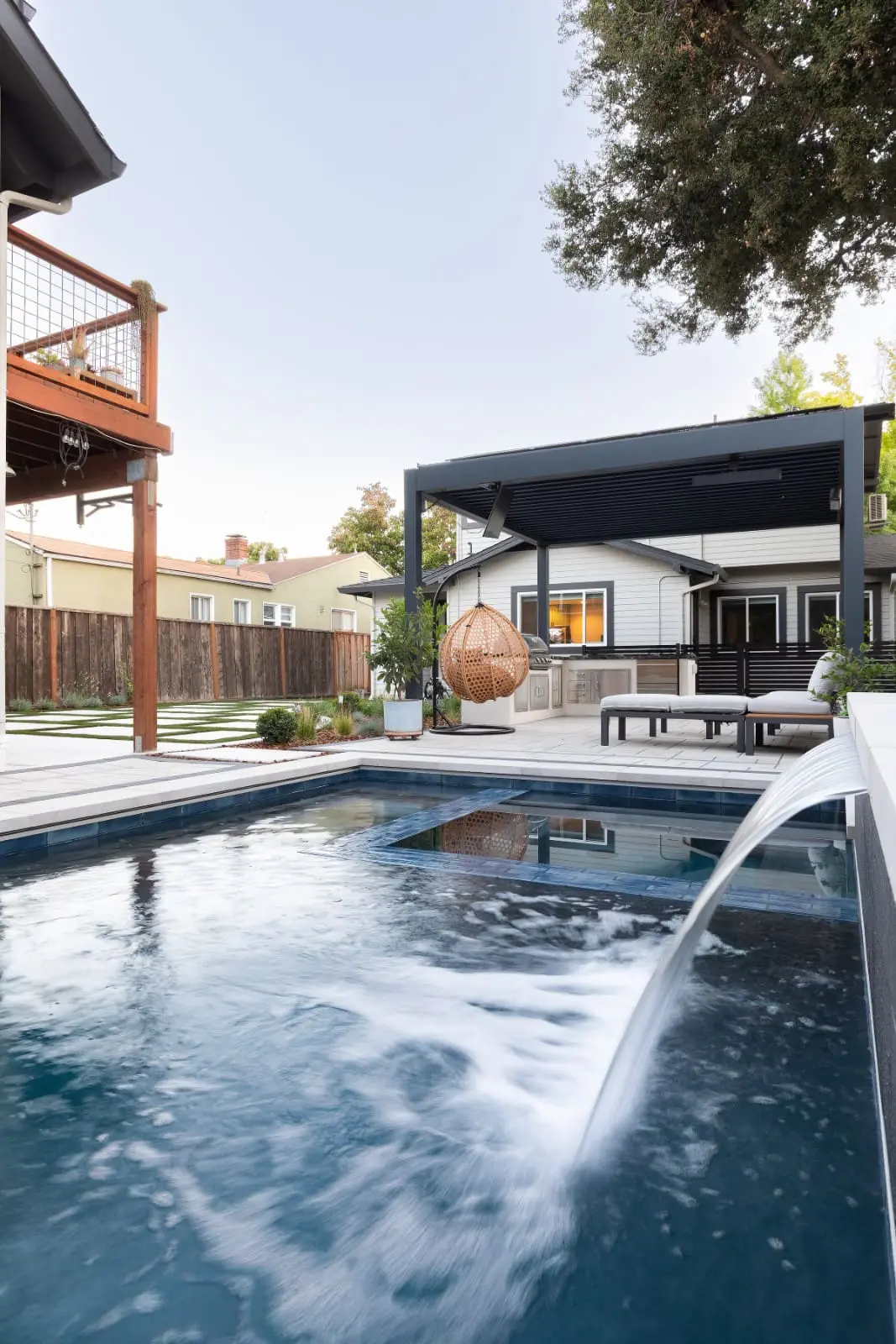 Keystone Yards custom backyard renovation featuring an inground swimming pool with a water feature, modern patio, and outdoor living space in Napa, CA.