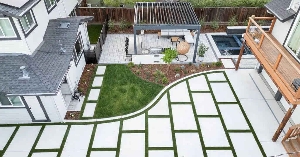 Aerial view of a backyard landscape design in Napa, CA with pergola, pavers, turf, and pool