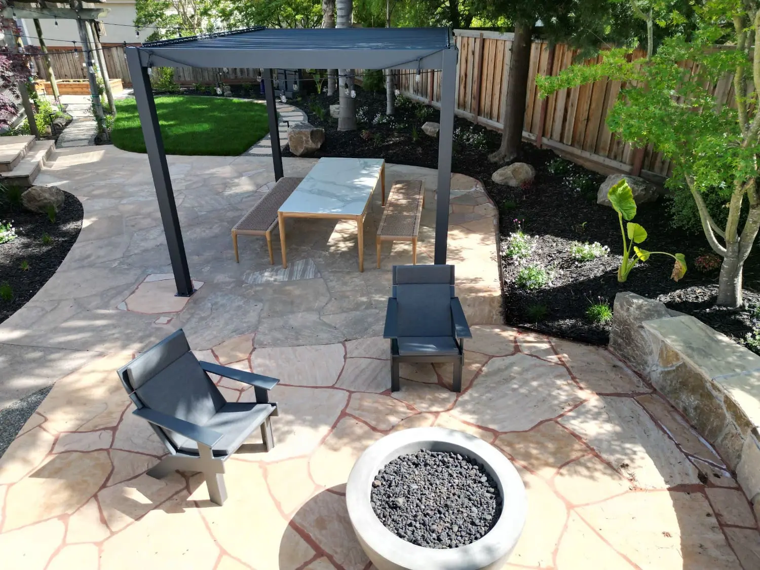 Custom stone patio, modern pergola, fire pit, and outdoor masonry services by Keystone Yards in Napa CA.