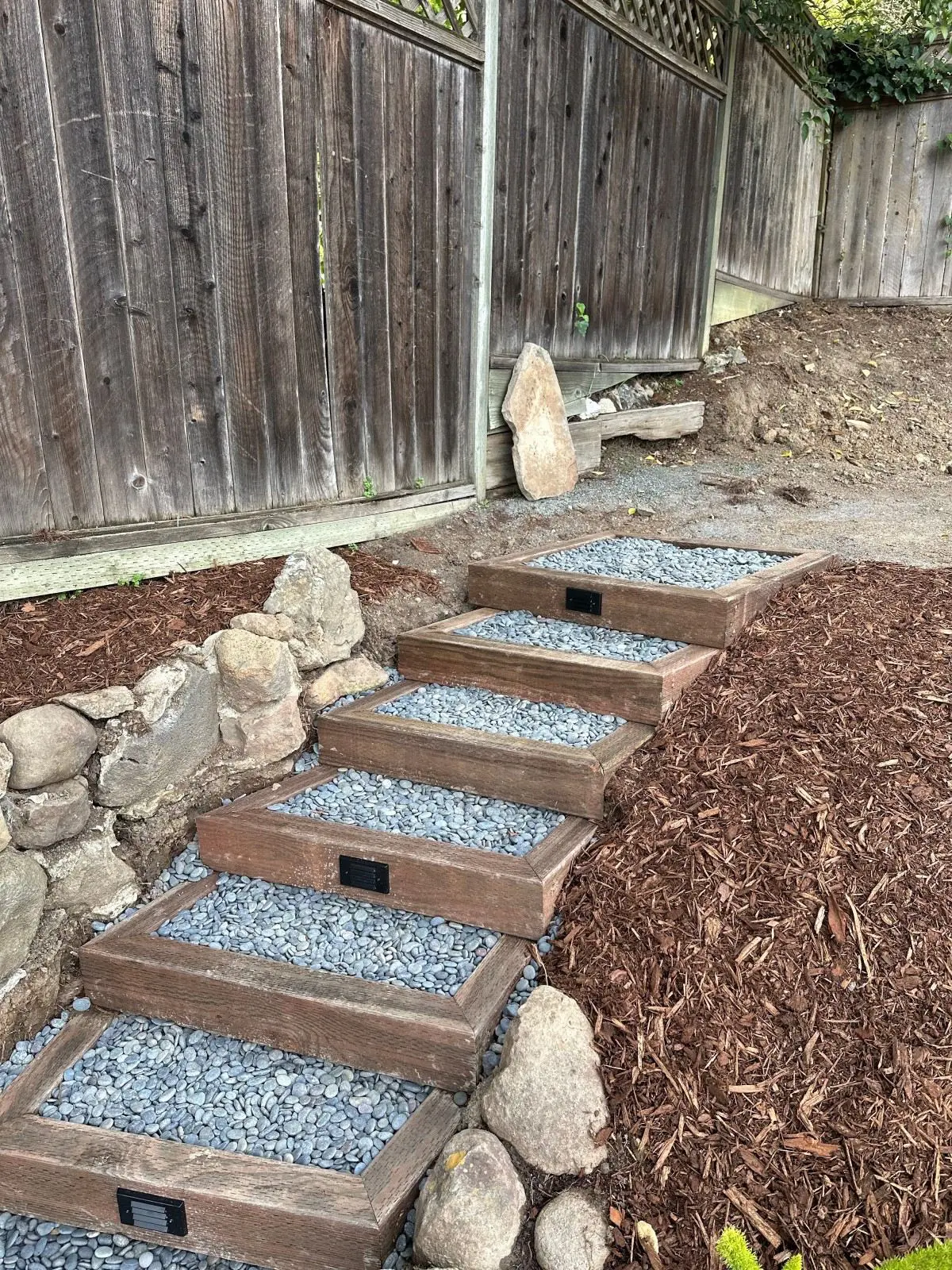 Hand-crafted landscape timber and gravel garden steps with low-voltage step lighting in Napa, CA.