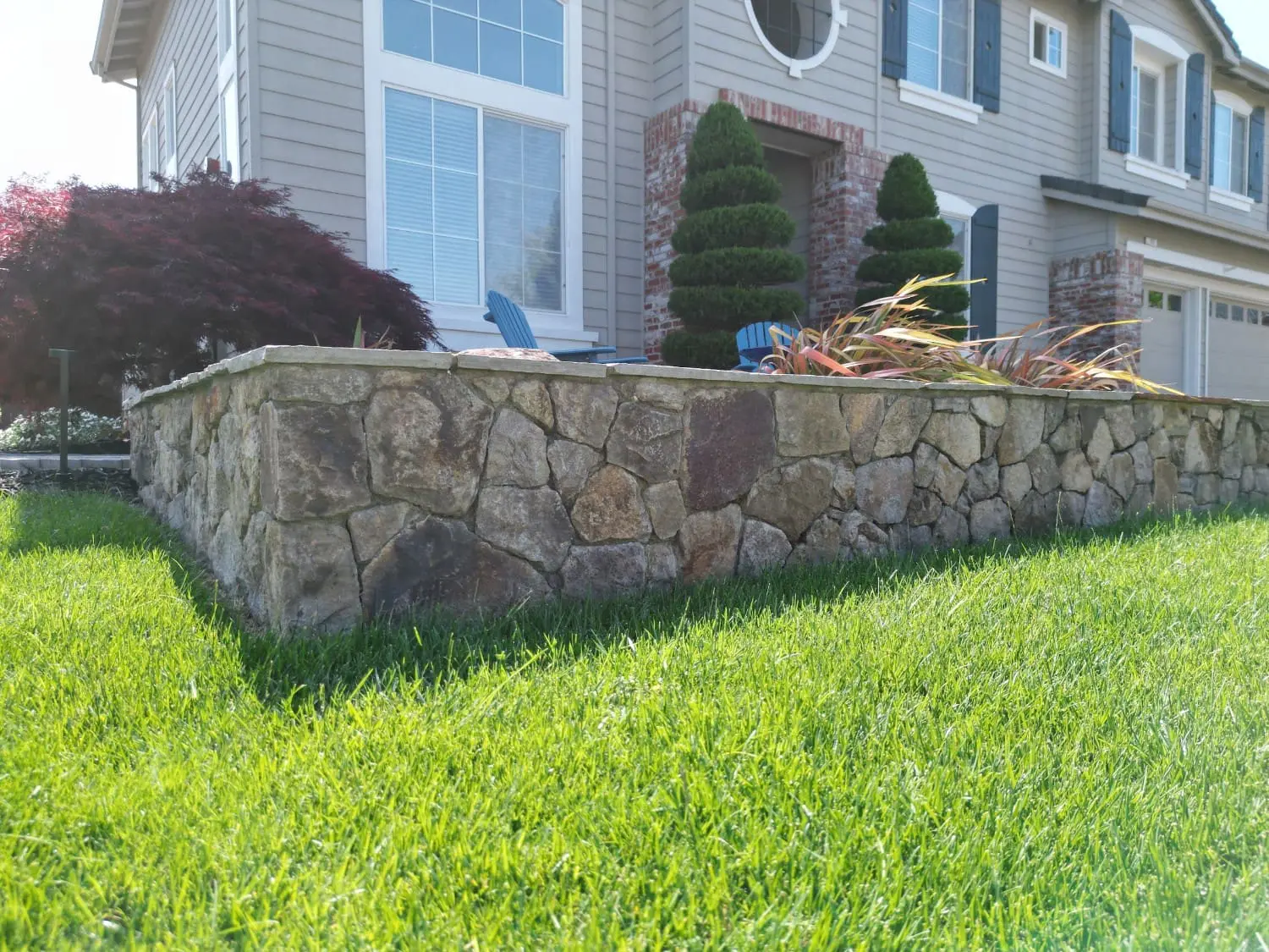 Hand-crafted stone retaining wall and professional landscaping in Napa, CA front yard by Keystone Yards.