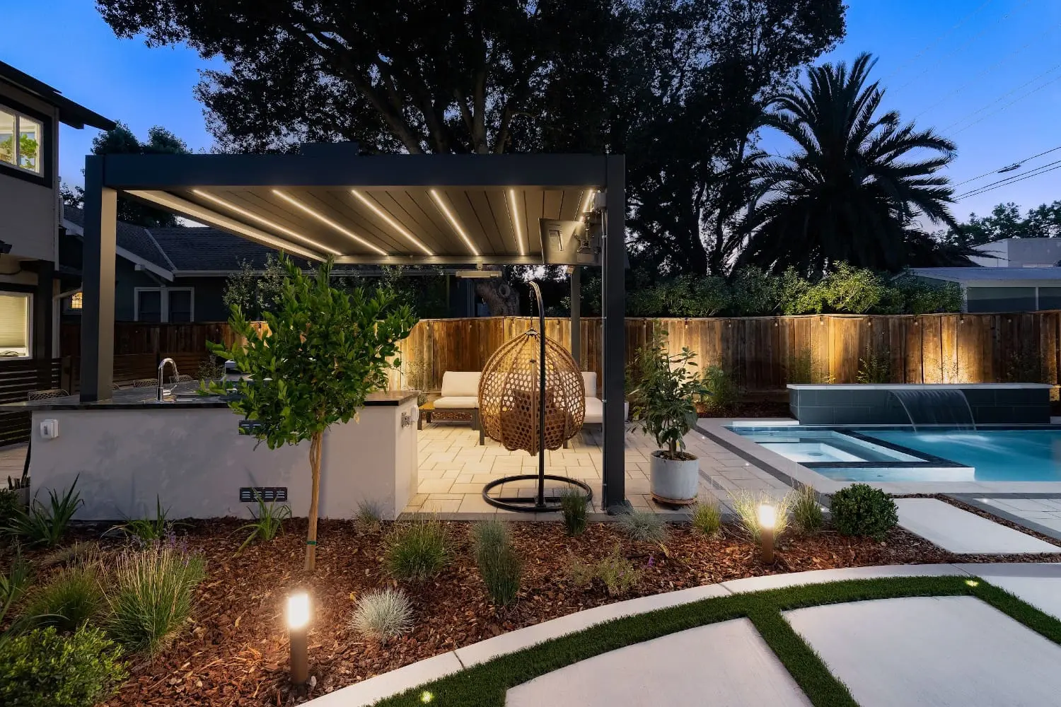 Outdoor electrical and lighting installation featuring a modern backyard patio, pool, pergola, and landscape lighting in Napa, CA.