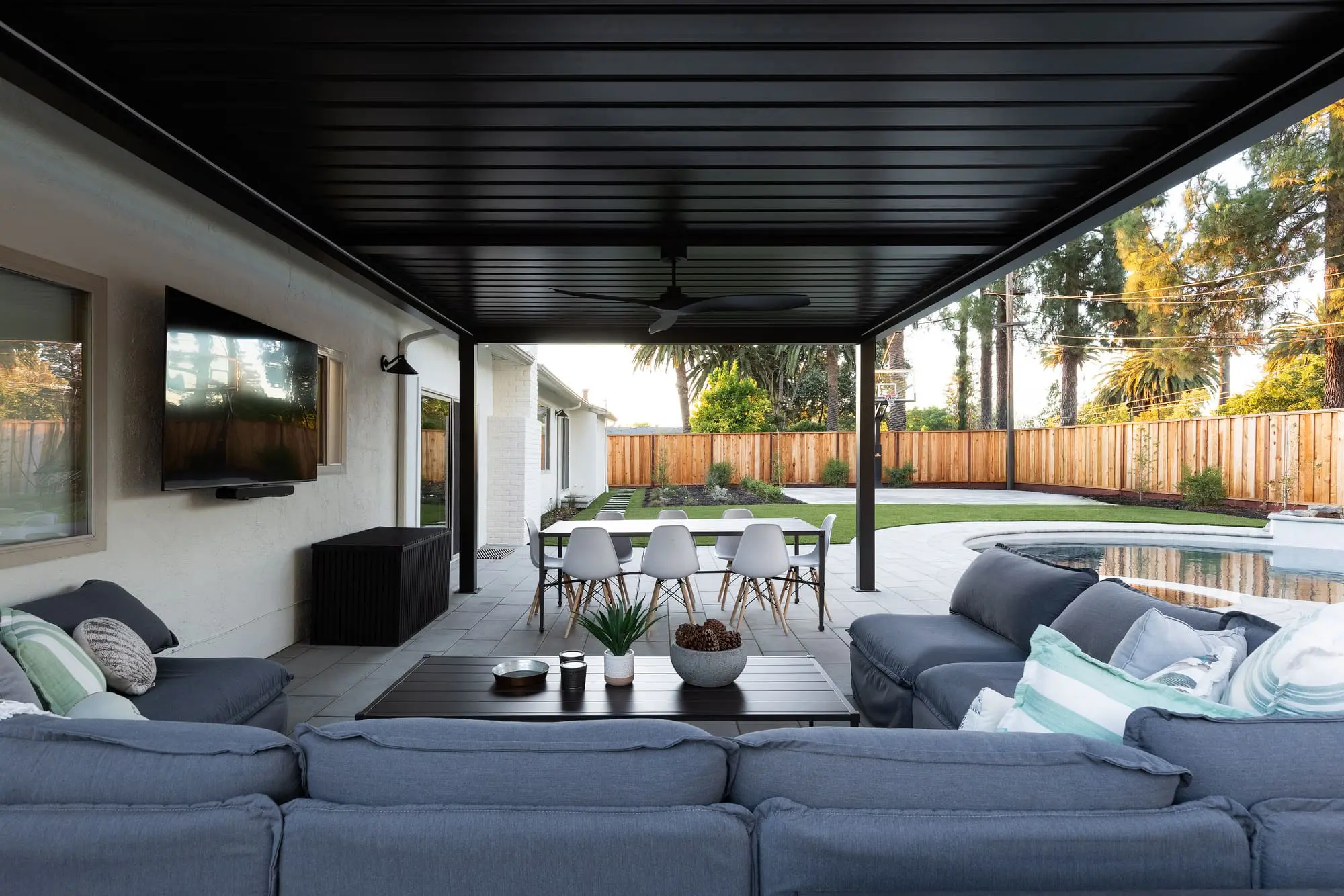 Custom design-build outdoor living space featuring a covered patio, modern outdoor seating, and a swimming pool in Napa, CA.