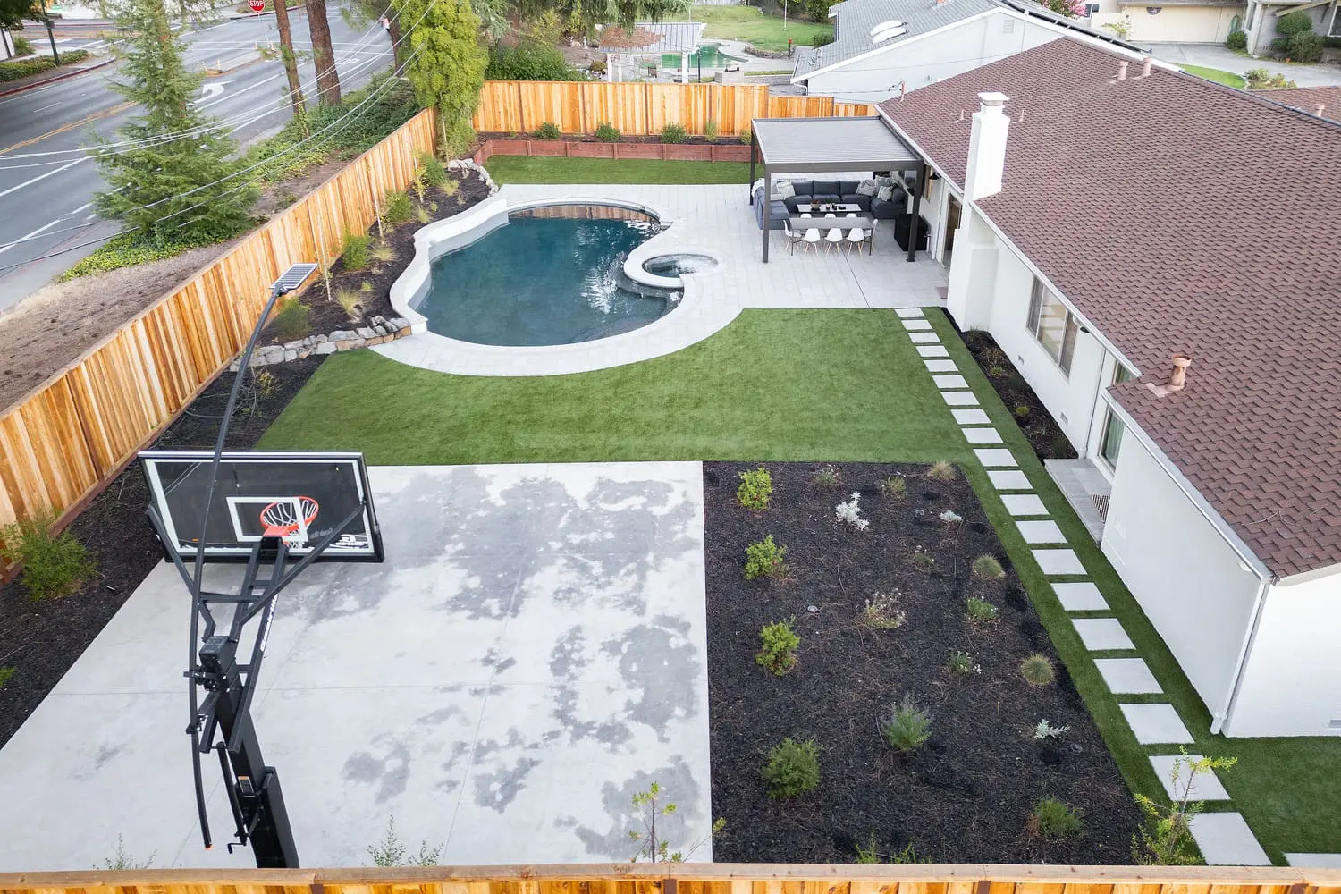 Aerial view of a custom backyard swimming pool, patio, and modern landscaping design built by keystone-yards-mill-valley-ca