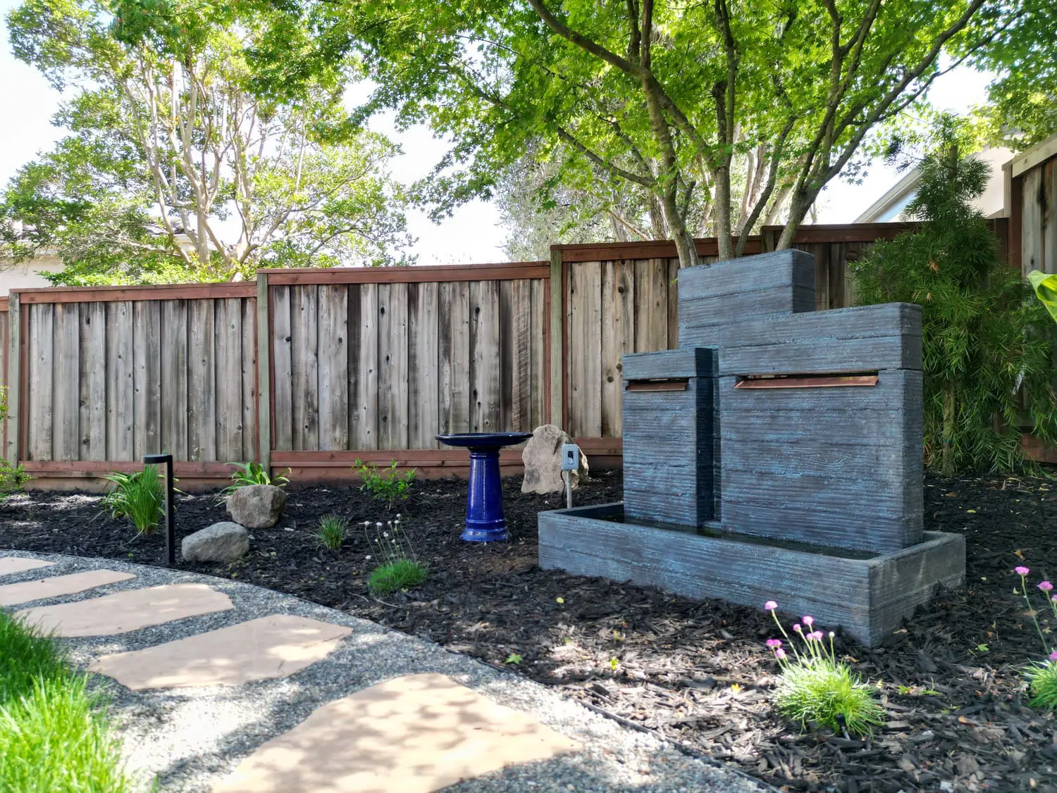 Custom residential stone walkway and lush green lawn landscape designed by keystone-yards-petaluma-ca