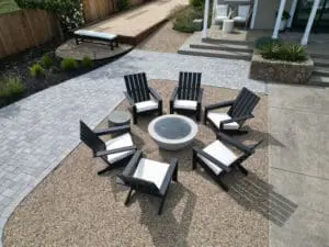 Modern backyard fire pit and stone patio seating area designed by keystone-yards-santa-rosa-ca
