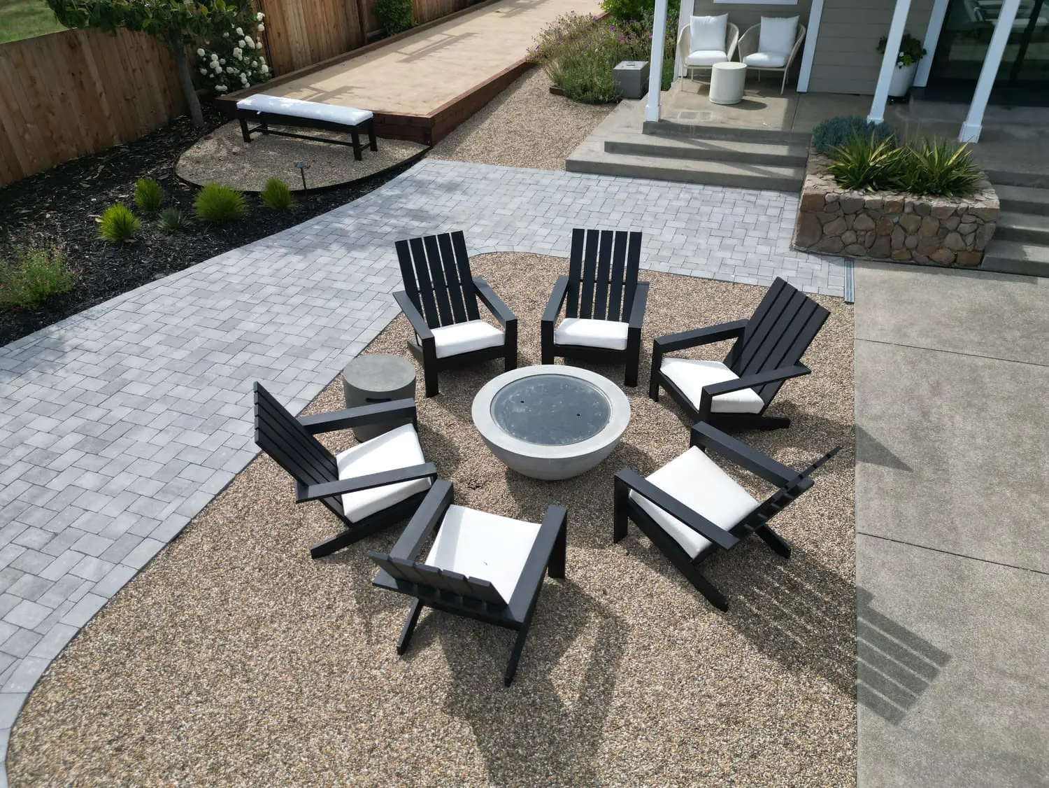 Modern backyard fire pit and stone patio seating area designed by keystone-yards-santa-rosa-ca