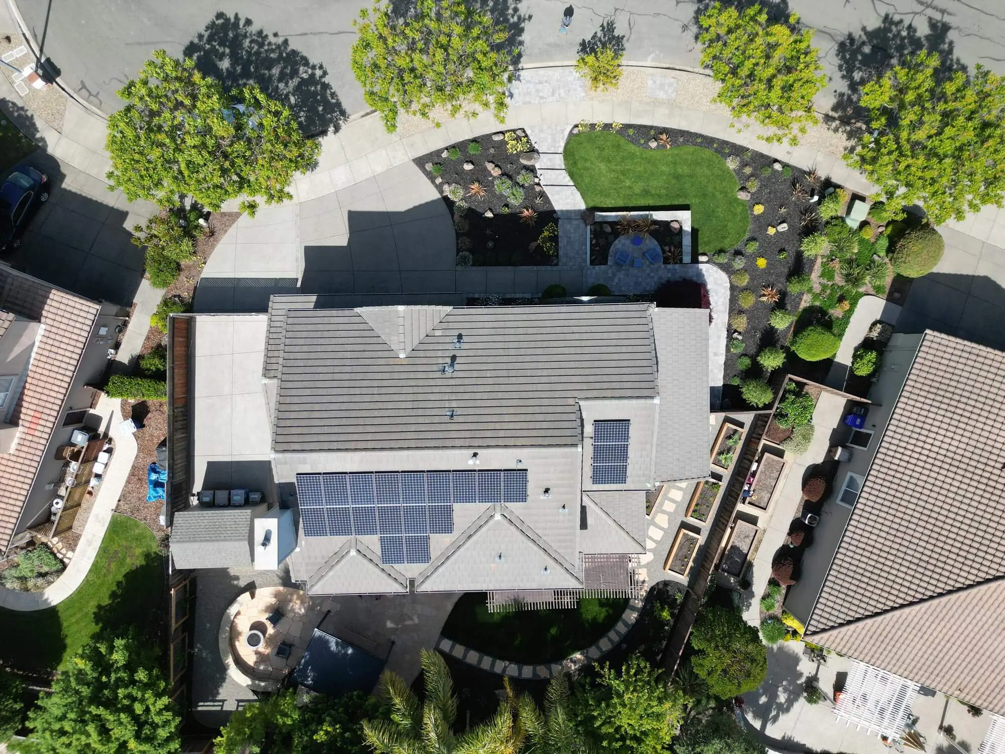 Aerial view of residential landscaping with solar panel roof and backyard patio by Keystone Yards in Napa CA