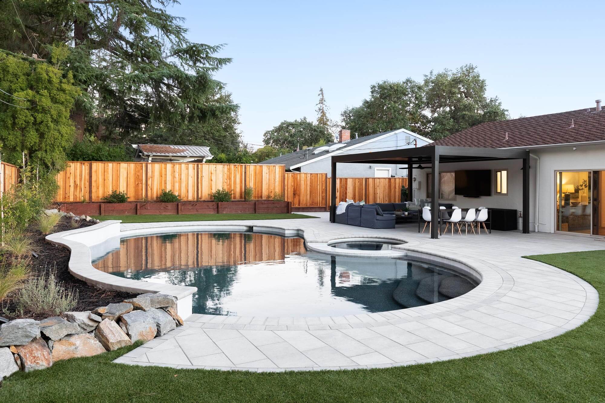Backyard pool and patio with pergola seating area, part of a landscape design in American Canyon, CA