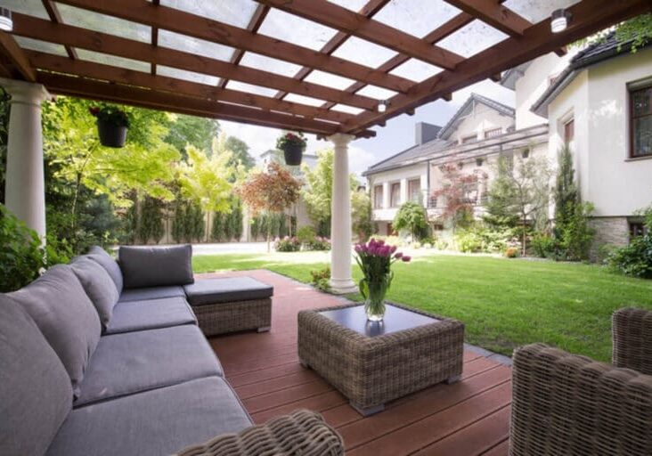Custom wood pergola with lattice roof shading a luxury outdoor patio and seating area.