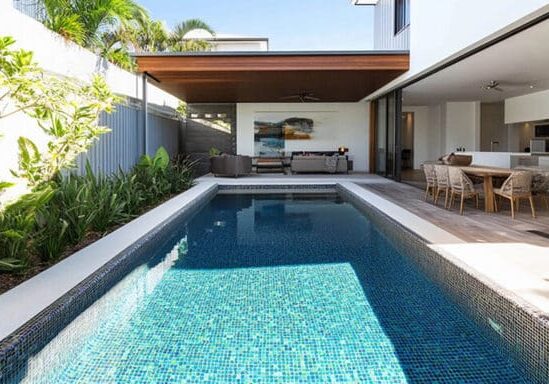 Luxury outdoor space with pool and outdoor living area showing plumbing and gas lines for luxury outdoor spaces integrated into the design